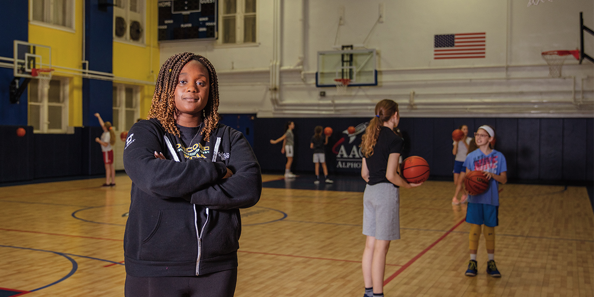 Alecia alongside kids playing basketball